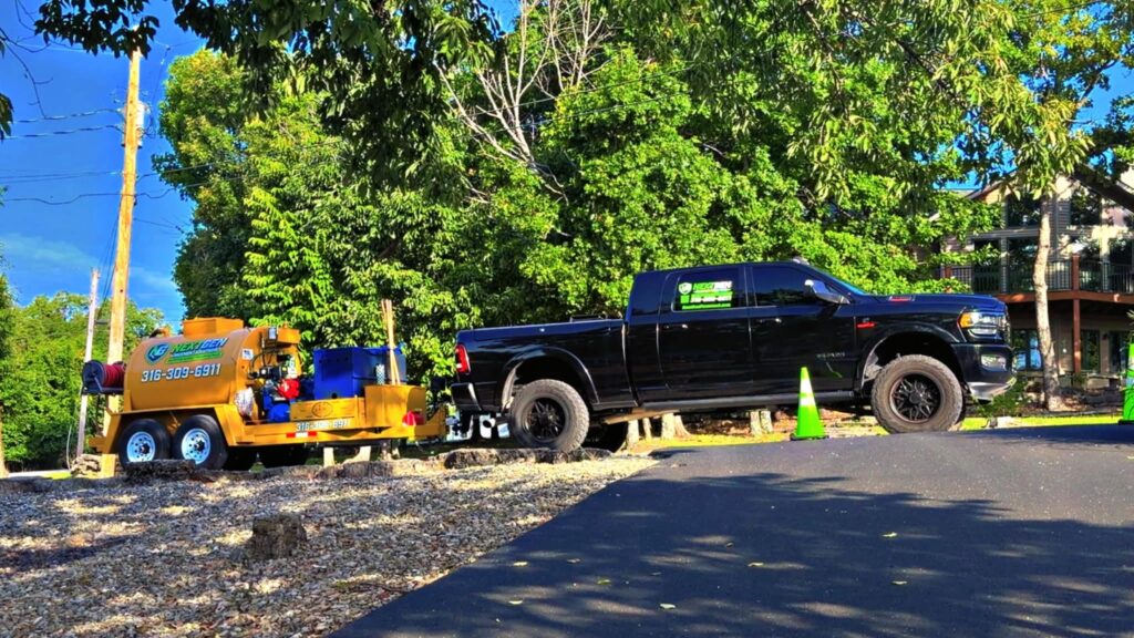 Freshly sealcoated residential driveway beside the NextGen truck and rig