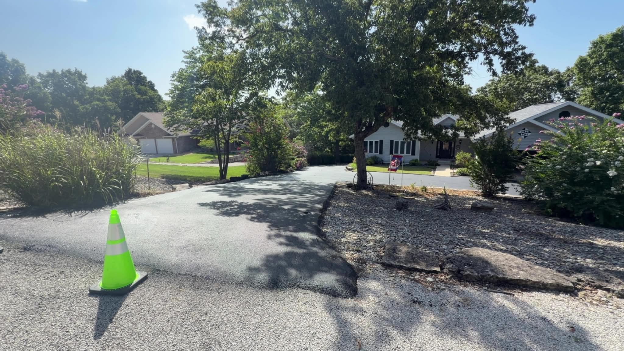 Careful Sealcoating for a Curved Residential Driveway Curved residential driveway before sealcoating preparation