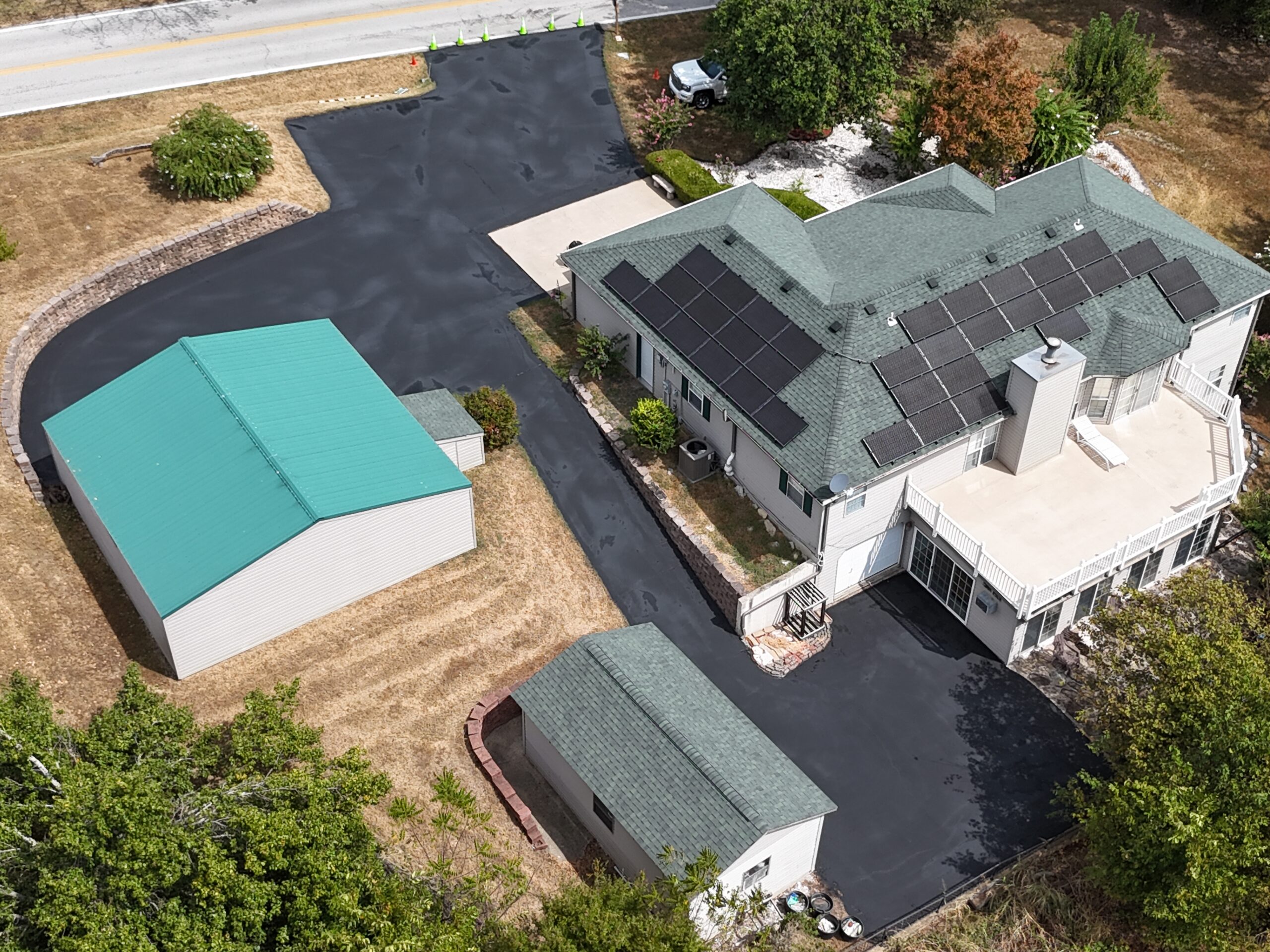 Finished pavement around a home and outbuildings in Walnut Shade