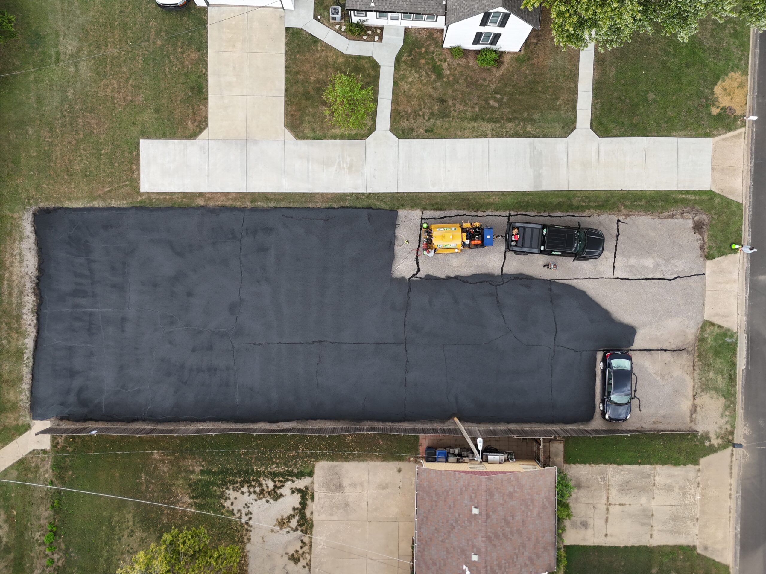 Aerial progress view of the freshly coated Grace Communion Derby parking lot, approximately ninety percent complete