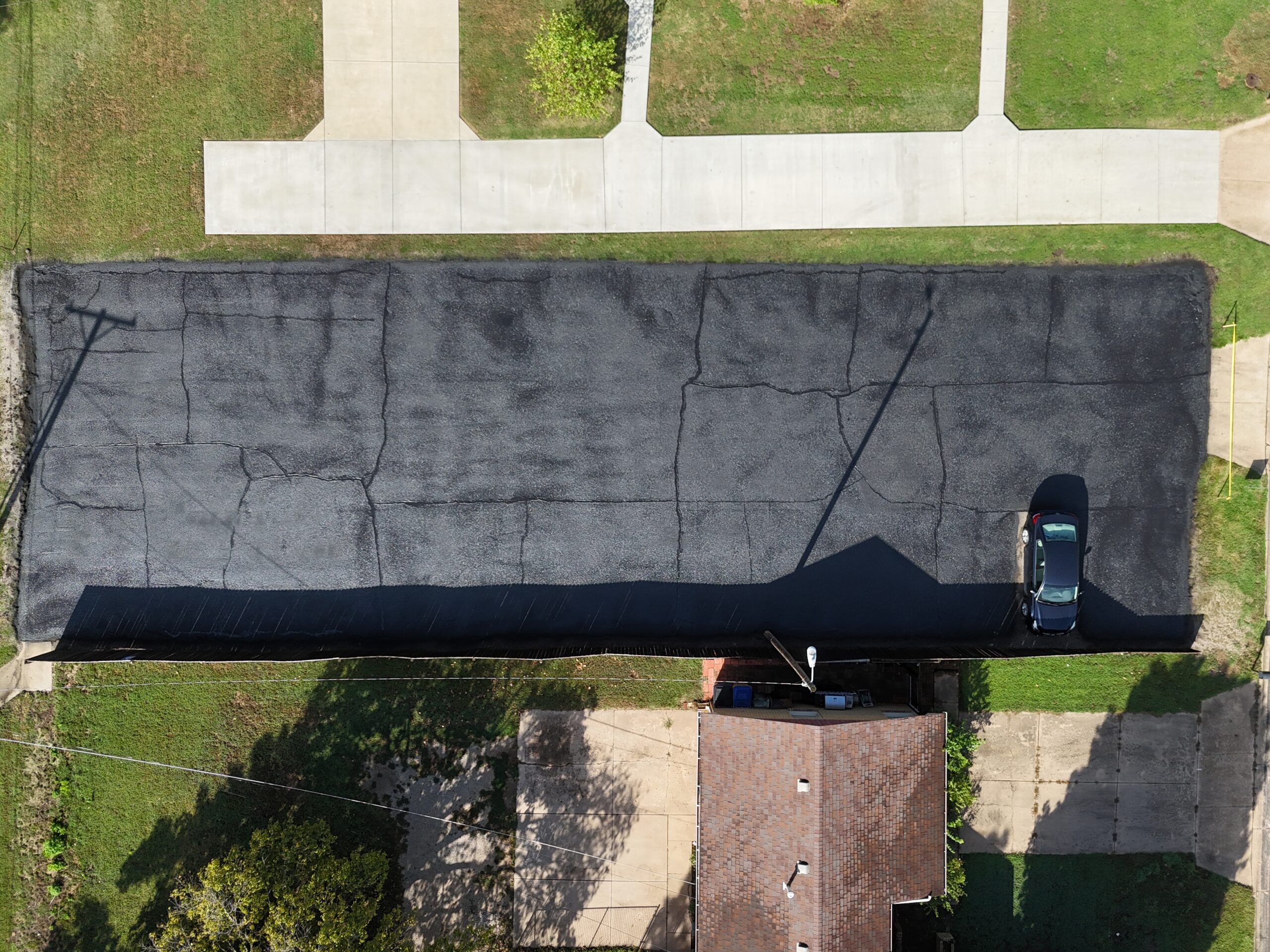 September 16 top-down view of the treated Grace Communion Derby parking lot before new striping