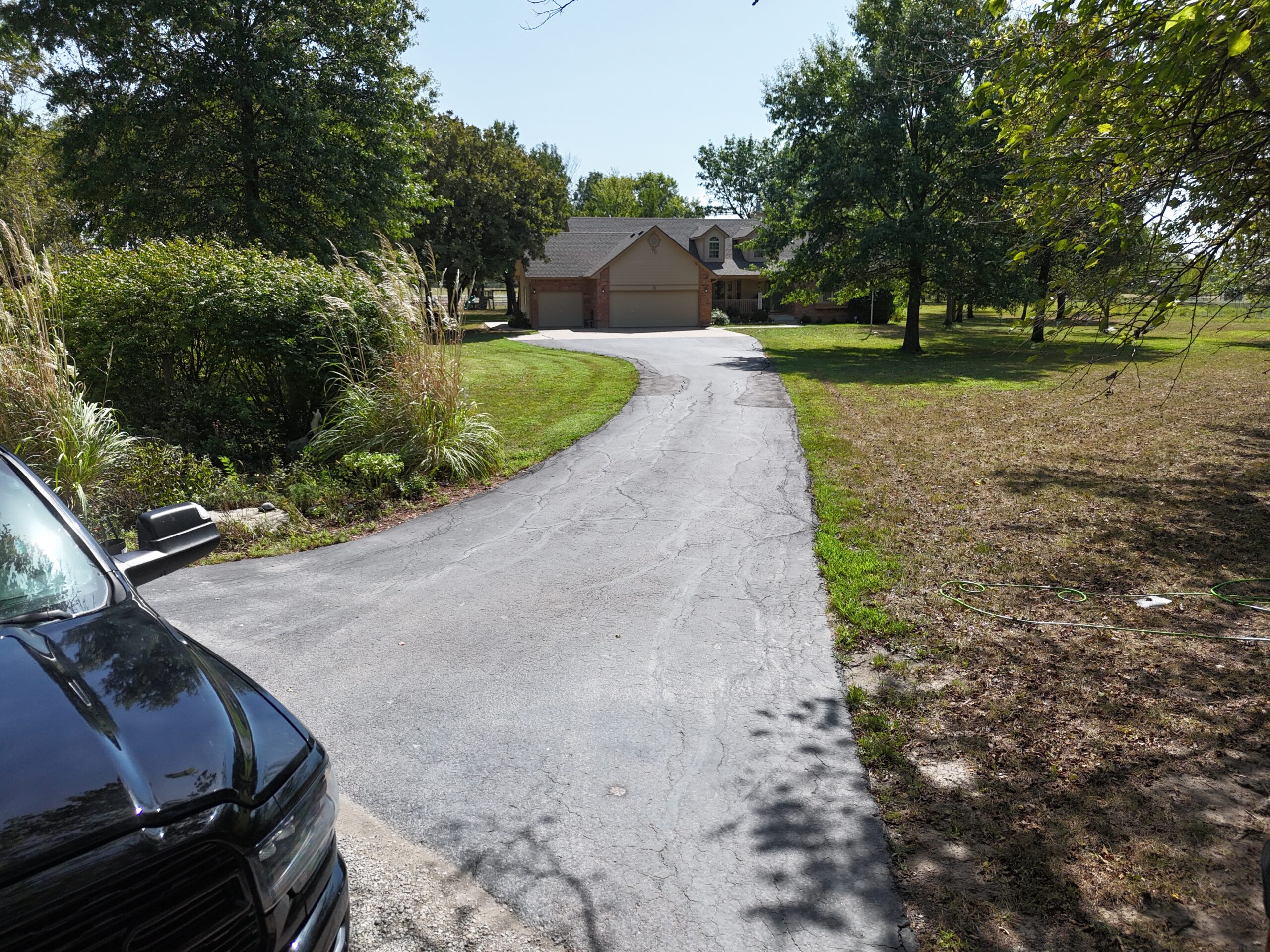 Weathered residential driveway in El Dorado, Kansas, before the September 16 pavement work