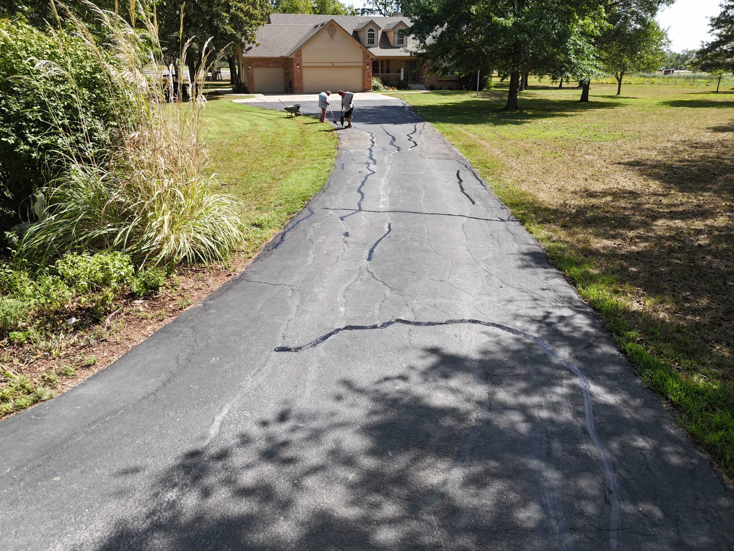 Crack-sealing work on a residential driveway in El Dorado, Kansas