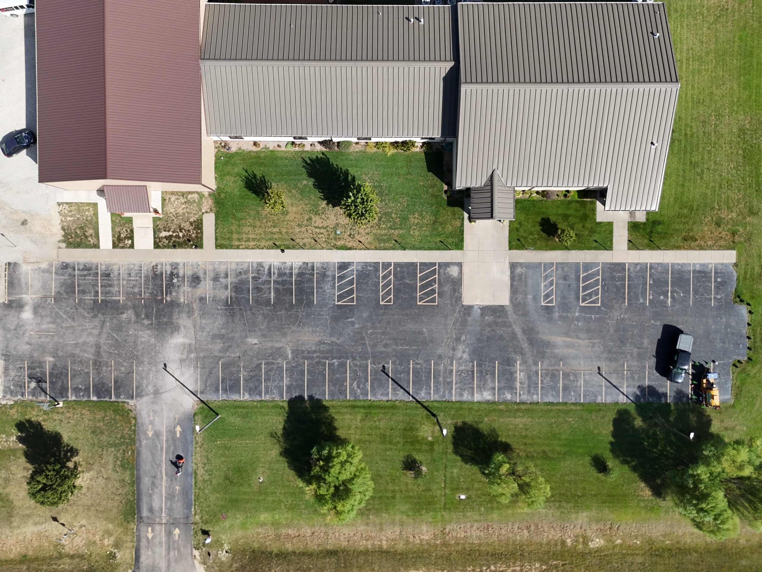 Early aerial view of the Freedom Church parking lot in Augusta, Kansas, with the weathered surface and old parking lines visible