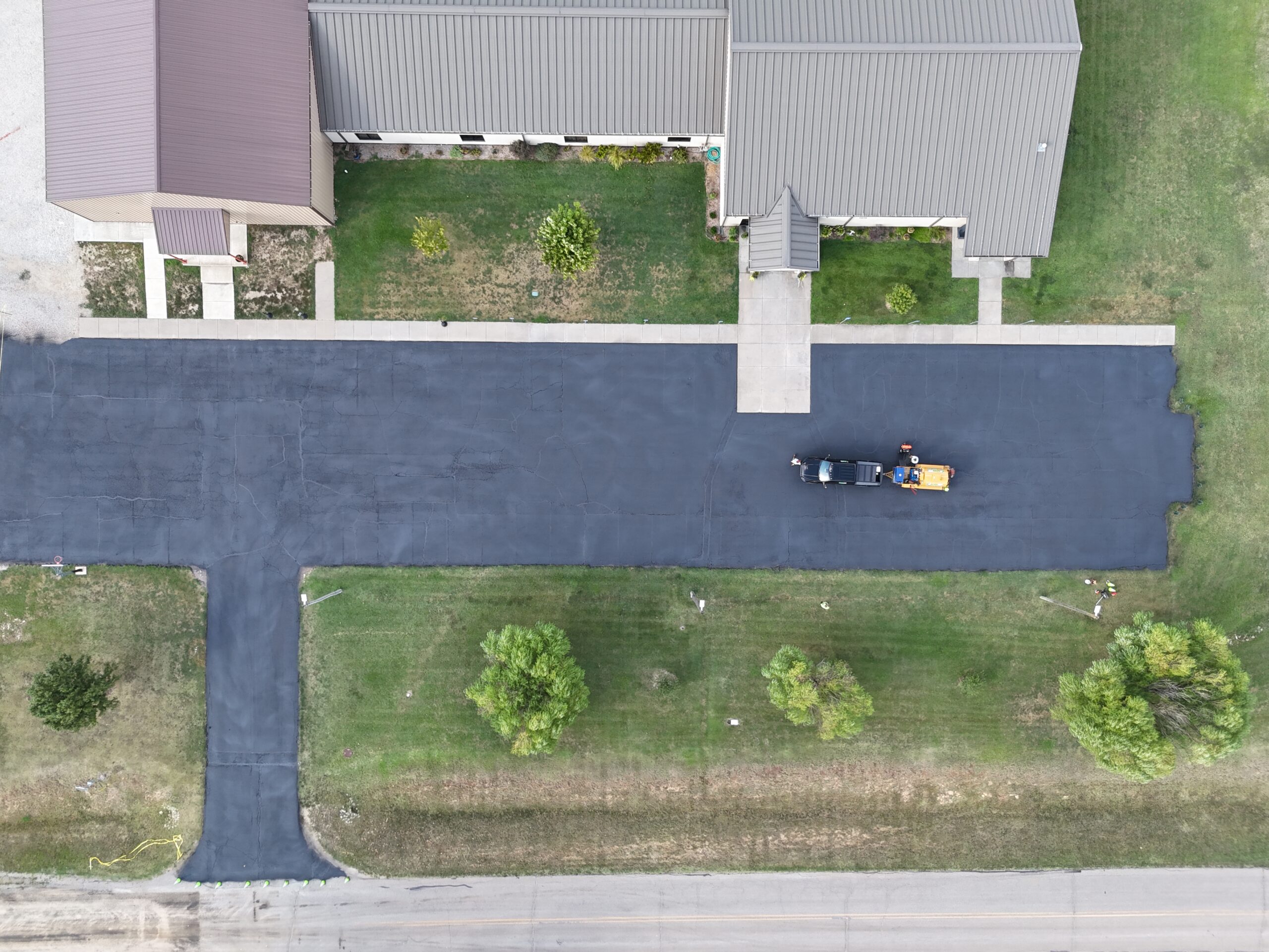 September 17 aerial of the freshly coated Freedom Church parking lot and entrance before new striping