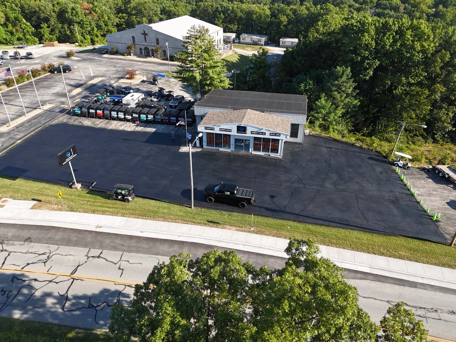 Home Freshly sealcoated front parking area at Horsin Around Golf Carts in Branson West, MO.
