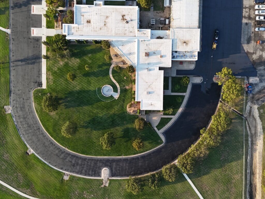 KTA Wichita Headquarters Sealcoating Overhead view of the KTA Wichita headquarters building and its curved sealcoated parking area on September 26