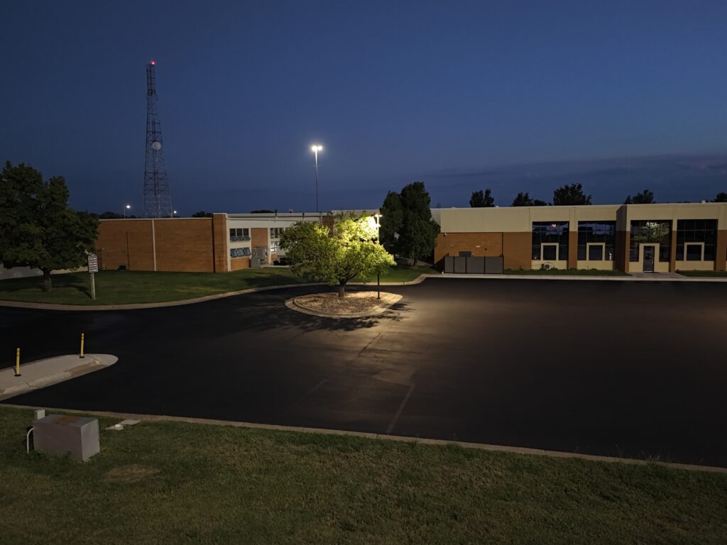 KTA Wichita Headquarters Sealcoating KTA headquarters entrance and newly sealcoated parking area illuminated at dusk on September 26