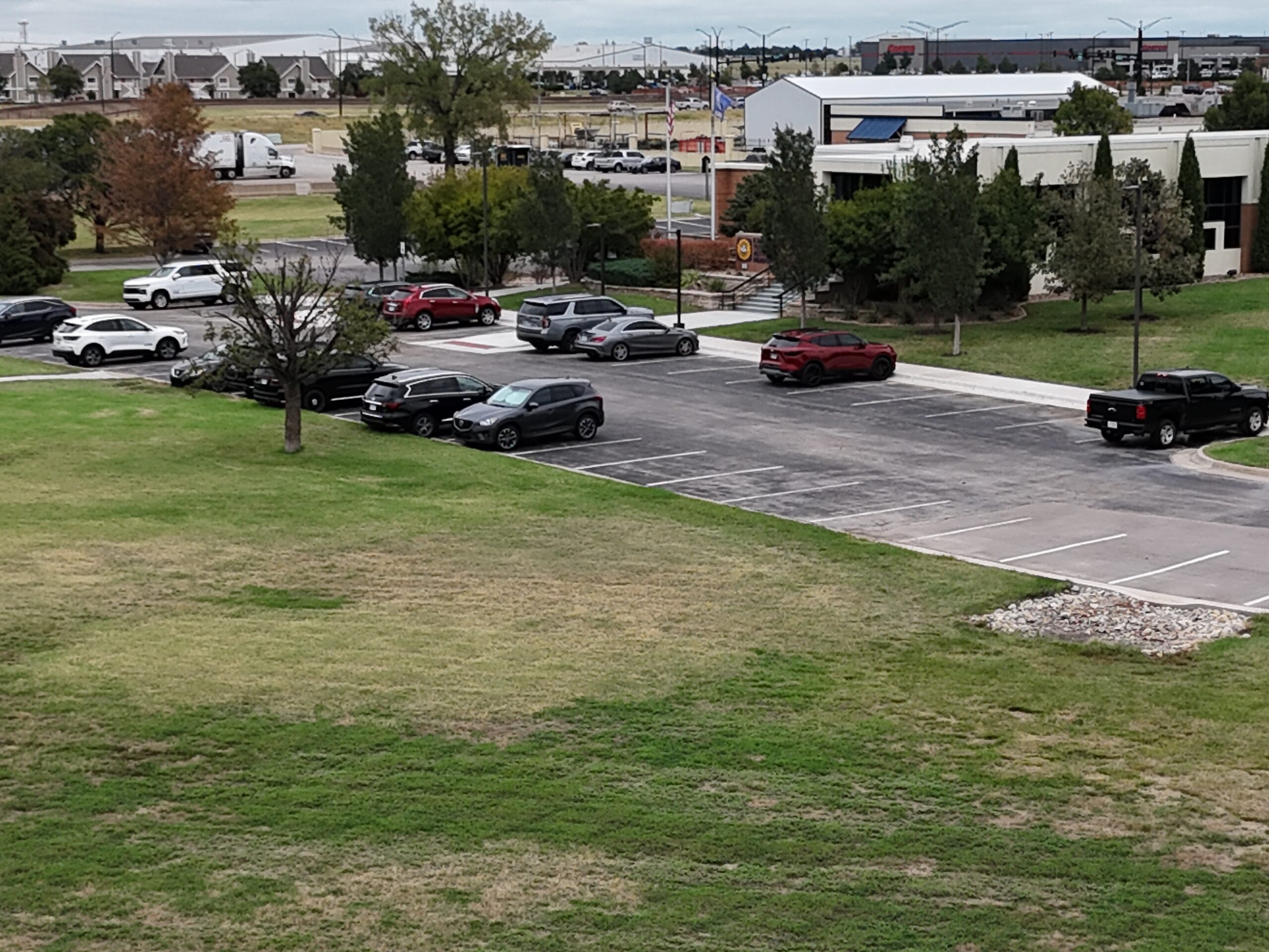 KTA Wichita Headquarters Sealcoating KTA headquarters parking lot before the sealcoating project, photographed September 21 with vehicles parked on the weathered pavement