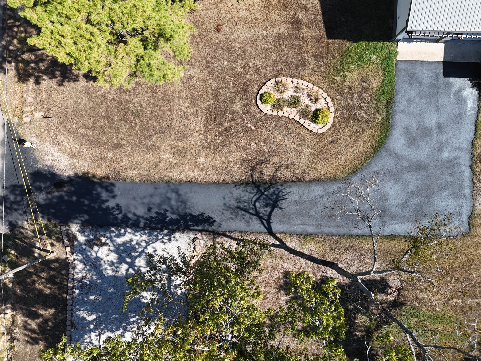 Aerial view of a freshly sealcoated residential driveway in Cape Fair, Missouri.