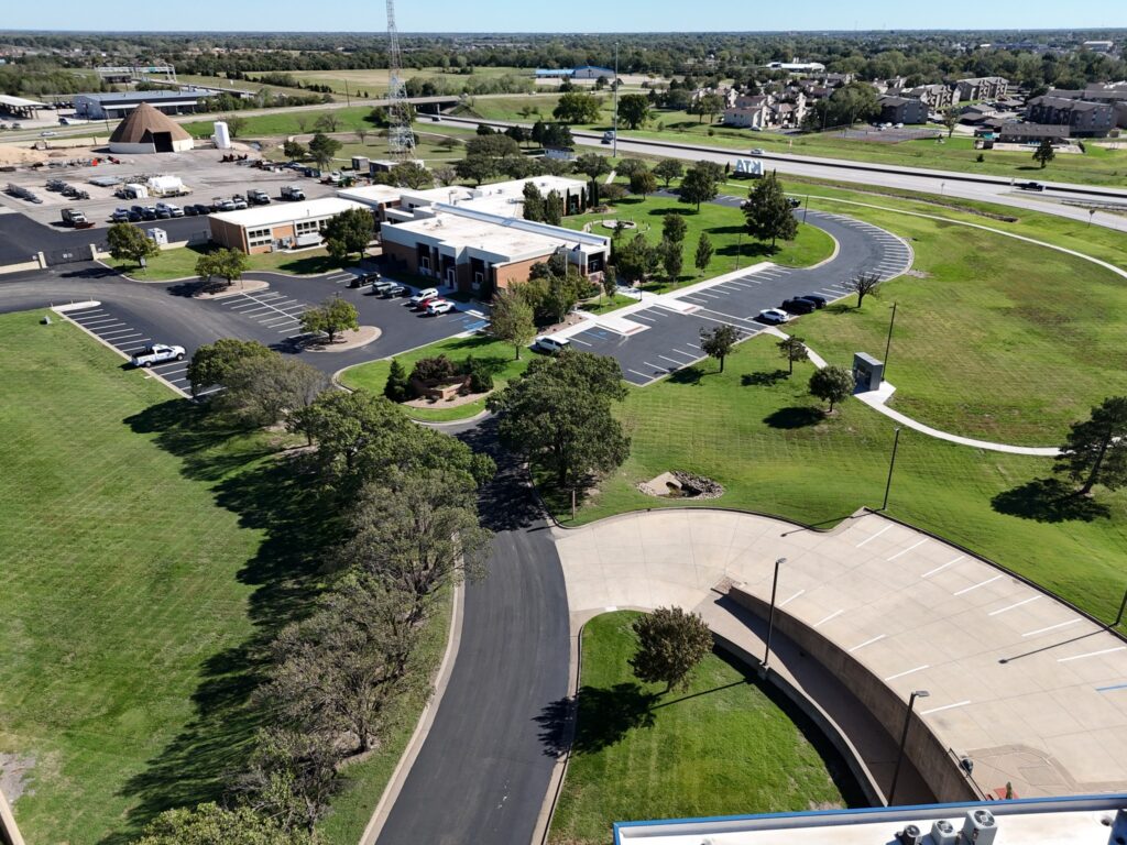 KTA Wichita Headquarters Sealcoating Wide aerial view of KTA Wichita headquarters with sealcoated pavement and completed parking stripes.