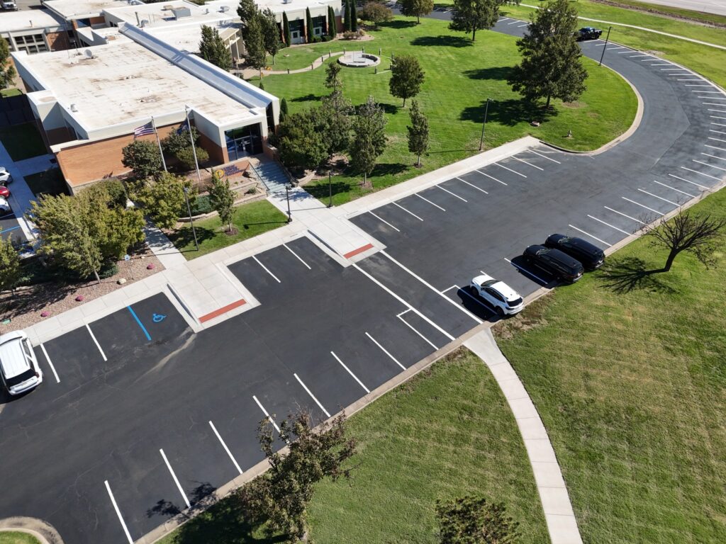 KTA Wichita Headquarters Sealcoating Aerial view of the front entrance at KTA Wichita headquarters and the finished striped parking layout.