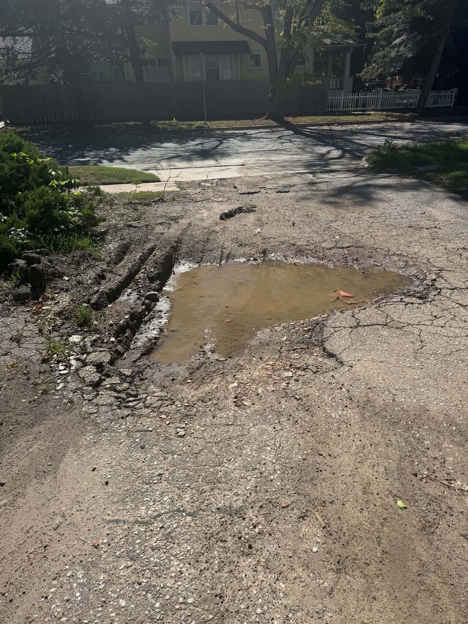 College Hill Pediatrics | Asphalt Repair & Sealcoating in Wichita Deteriorated asphalt area during repair preparation at College Hill Pediatrics