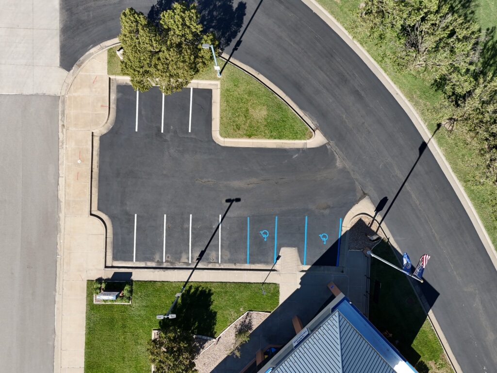 KTA Wichita Headquarters Sealcoating Aerial view of completed parking-space markings on sealcoated pavement at KTA Wichita headquarters.