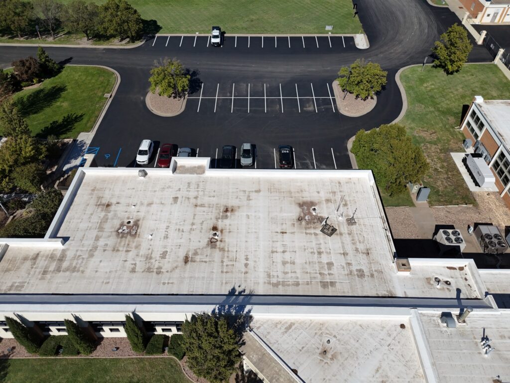 KTA Wichita Headquarters Sealcoating Oblique aerial view of the KTA headquarters roof, courtyard and surrounding marked parking areas.